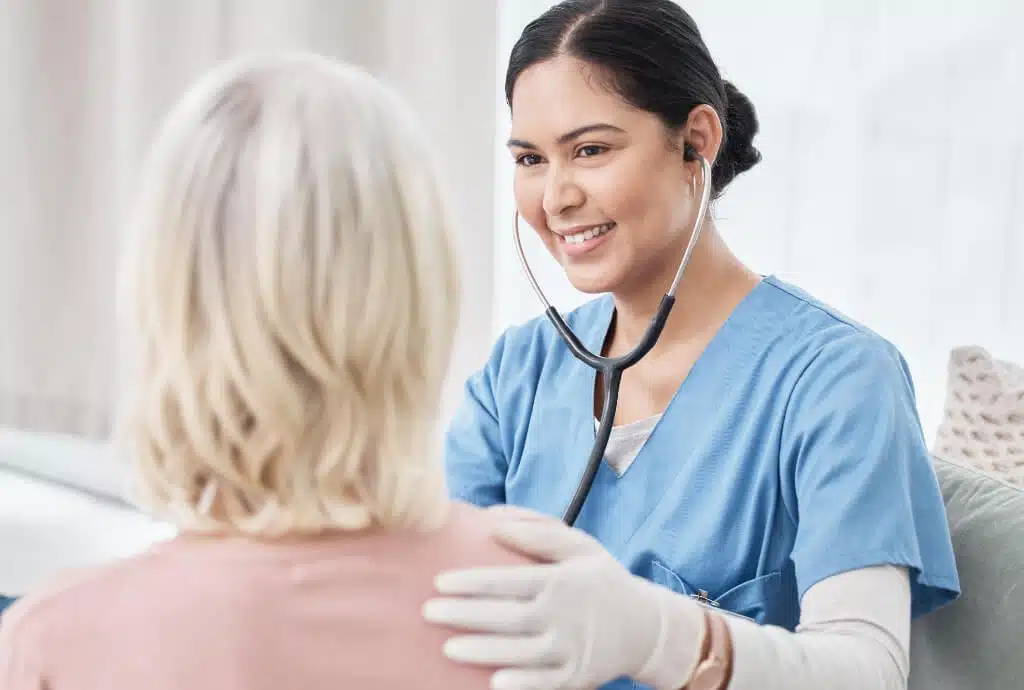 Medical professional providing at-home care during a 24/7 house call visit.