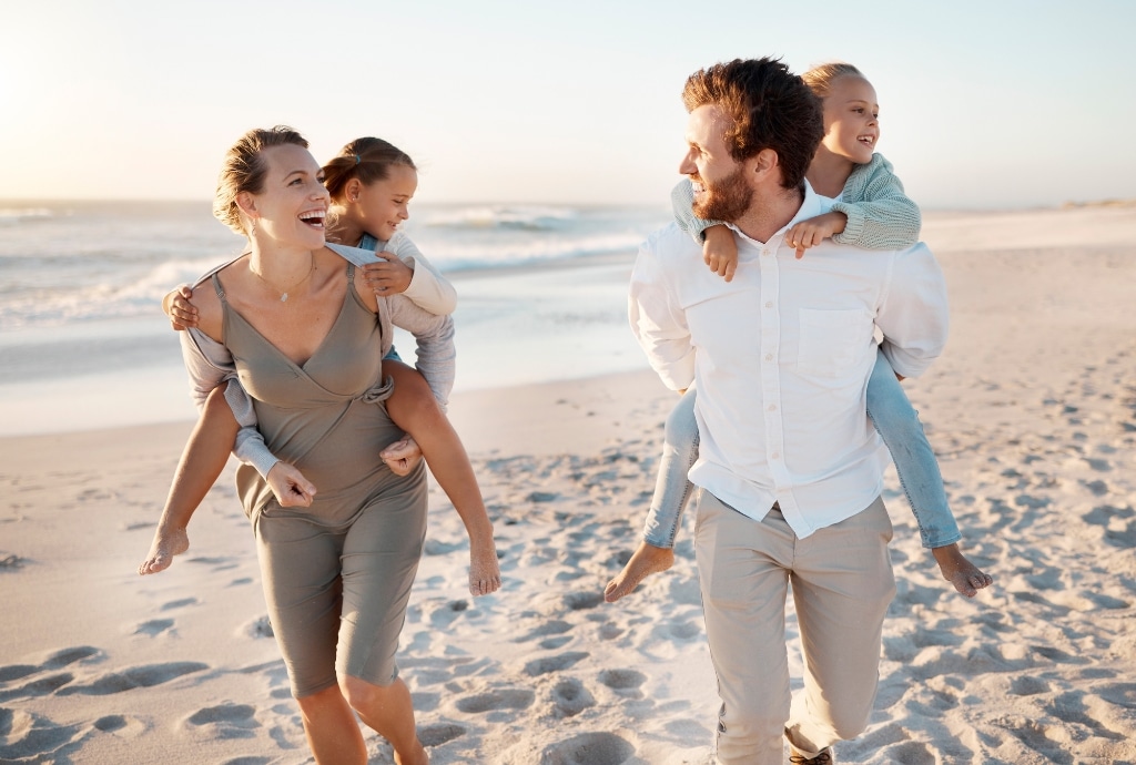 Family enjoying time together on the beach during the summer season.
